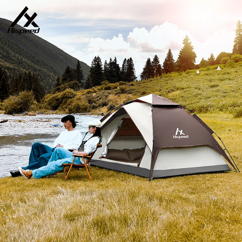 3-4 Person Automatic Dome Tent pitched by a river with campers relaxing alongside